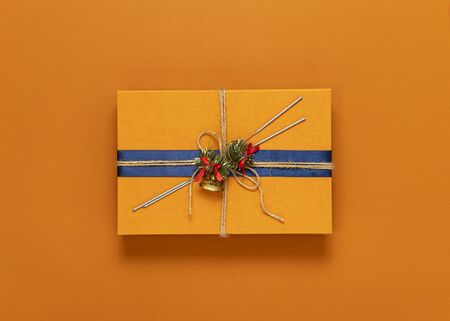 bright orange background, in the center an orange gift box, top view, horizontal frame, copy spaceの写真素材