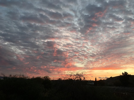 Natural Sunset Sunrise Over village. Bright Dramatic Sky And Dark Ground. Countryside Landscape Under Scenic Colorful Sky At Sunset Dawn Sunrise. Sun Over Skyline, Horizon. Warm Colours.の写真素材