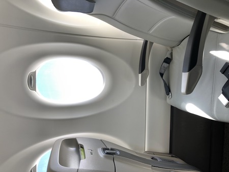 Airplane seat and window inside an aircraft photoの写真素材