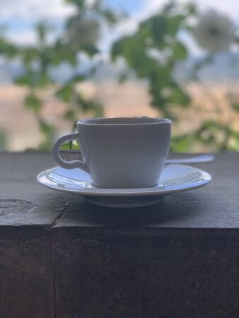 A cup of coffee on table with Italian town Florence at the backgroundの写真素材