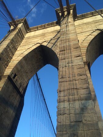 A view of the Brooklyn Bridge in New York City.の写真素材