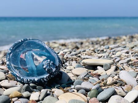 Snorkel gear by the sea. swimming mask scuby on the pebble beachの写真素材