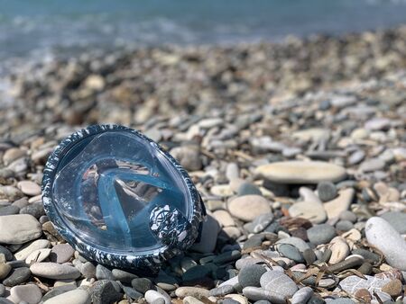 Snorkel gear by the sea. swimming mask scuby on the pebble beachの写真素材