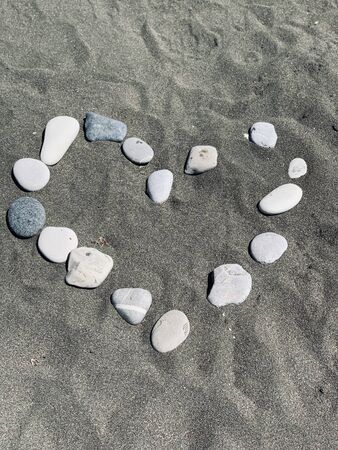 heart from the stones on sandy beachの写真素材