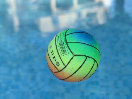 Beach volleyball ball floating in swimming pool. Copy spaceの写真素材