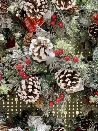 Christmas wreath with wild berries, conifer cones, spruce branches backgroundの写真素材