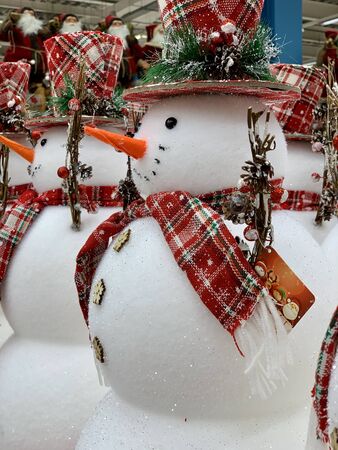 Big christmas snowman with red scarf and hat standing at the hat's retail shopの写真素材
