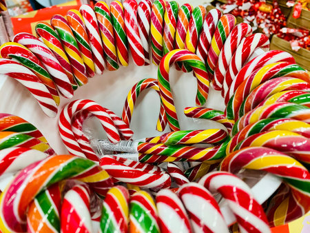 colorful candy canes in bucket in the shop. christmas candy