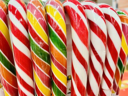 colorful candy canes in bucket in the shop. christmas candyの写真素材