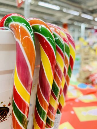 colorful candy canes in bucket in the shop. christmas candyの写真素材