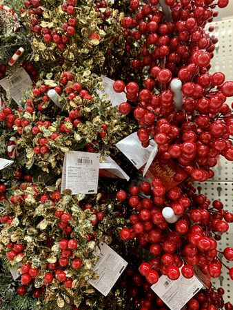 Christmas wreath with wild berries, conifer cones, spruce branches backgroundの写真素材