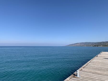 Wooden jetty over the beautiful sea with blue skyの写真素材