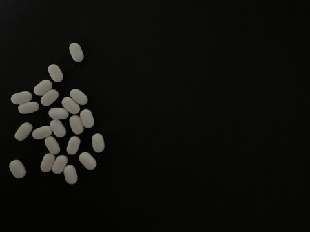 tablets and pills or vitamines capsules on dark background