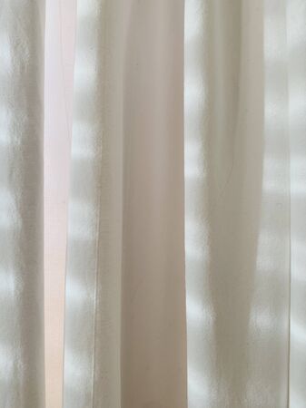Sunlight through the white curtain and windows in the bedroom in the morningの写真素材