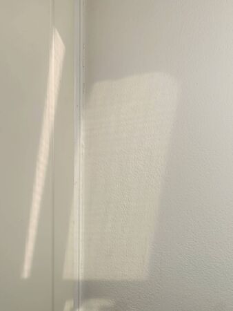 shadow on white wall for mock up sunlight through the windowの写真素材