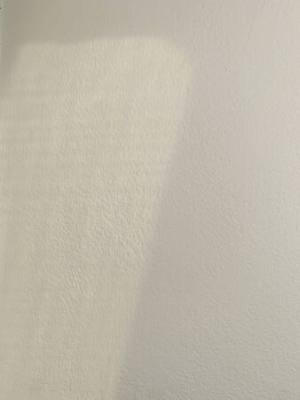 shadow on white wall for mock up sunlight through the windowの写真素材