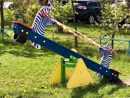 Empty childrens swing in playground closed during Coronavirus Covid-19 quarantineの写真素材