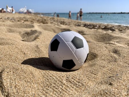 Football soccer ball on sandy beach backgroundの写真素材