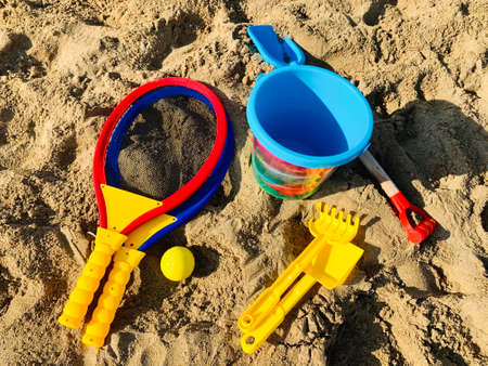 Vacation image of children's beach plastic toys on the sandの写真素材