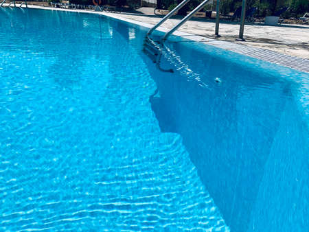 Close-up of ladder in swimming pool in resort, summer dayの写真素材