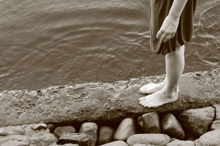 Young woman in beautiful dress walking near Neva river. Summerの写真素材