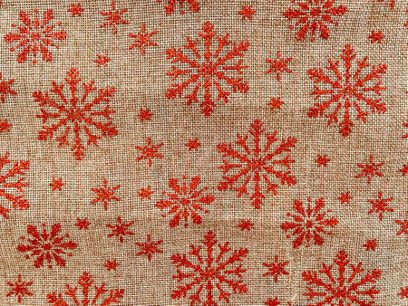 christmas canvas red tablecloth background with snowflakesの写真素材