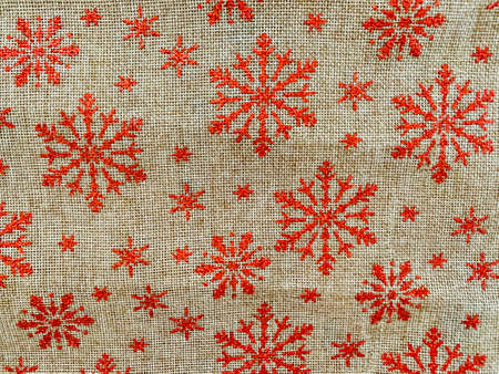 christmas canvas red tablecloth background with snowflakesの写真素材