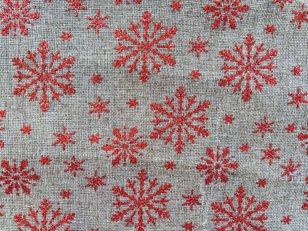 christmas canvas red tablecloth background with snowflakesの写真素材