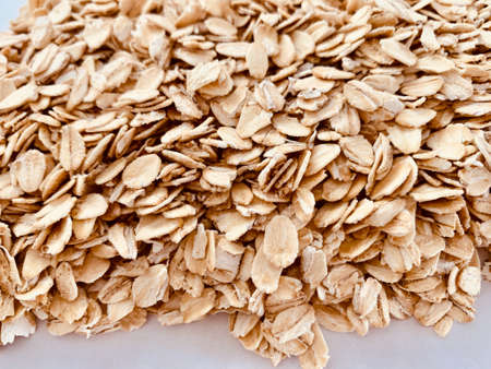 jumbo organic oats flakes on white backgroundの写真素材