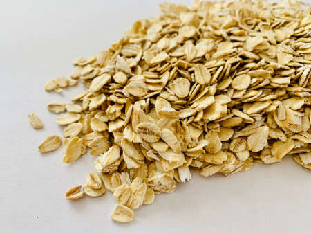 jumbo organic oats flakes on white backgroundの写真素材