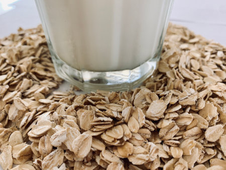 Glass of oat milk isolated on white backgroundの写真素材