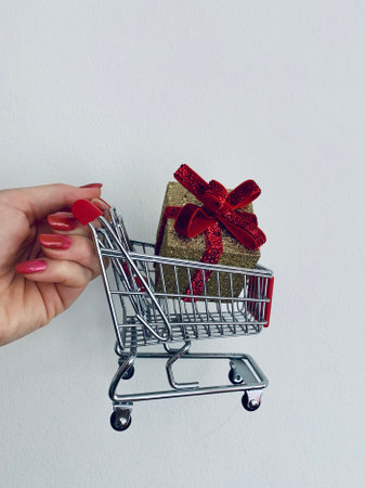 Shopping cart and giftboxes on white backgroundの写真素材