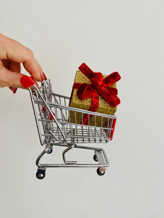 Shopping cart and giftboxes on white backgroundの写真素材