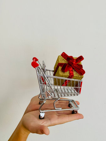 Shopping cart and giftboxes on white backgroundの写真素材