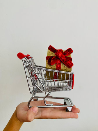 Shopping cart and giftboxes on white backgroundの写真素材