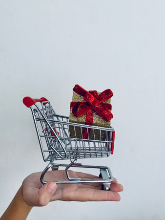 Shopping cart and giftboxes on white backgroundの写真素材