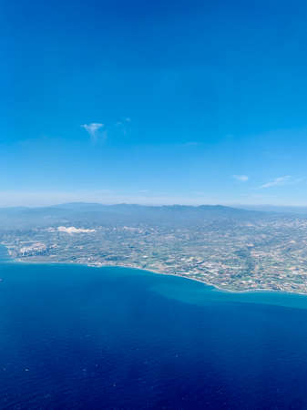 Aerial view of Cyprus shore above Mediterranean Sea at the Middle East. picturesque view from window seat in vacation economy flightの写真素材