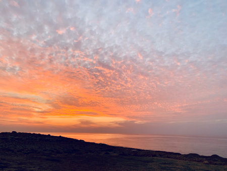 Pink orange Sunset over the sea Burning Down Cyprusの写真素材