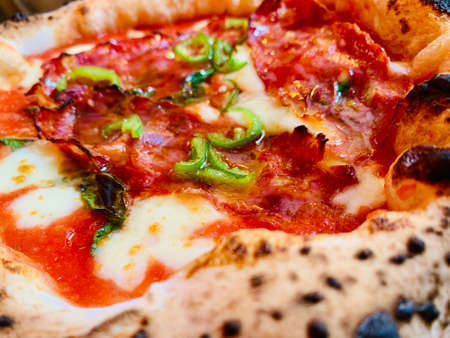 Pizza background - macro shot of pizza from stoveの写真素材