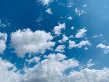 Strong sun, blue sky and cumulus white clouds.の写真素材