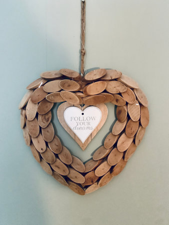 wooden heart decoration isolated on white background om the wallの写真素材