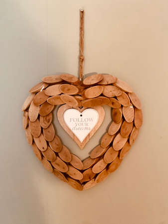 wooden heart decoration isolated on white background om the wallの写真素材