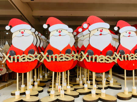 Merry Christmas Santas decoration dolls sitting on shelf togetherの写真素材