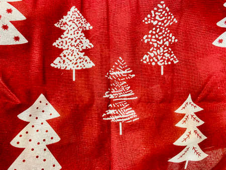 Christmas background white and red crumpled closeup with deers hearts fir trees starssnowflakesの写真素材