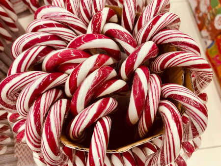 Candy canes with red and white stripes in the supermarketの写真素材