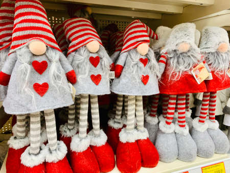 red gnome Santa Claus sale on bazaar Christmas souvenirs on a shelf in a kiosk for tourist Christmas holiday market placeの写真素材