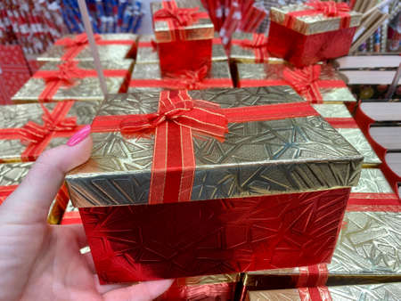 Best Christmas gift. Woman hands holding empty craft gift box, preparing surprise for holiday, side viewの写真素材
