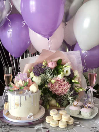 wedding or birthday table with flowers and candles cakes champagne in trendy coloureの写真素材