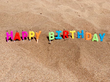 Happy birthday candles on sandy beach. colorfulの写真素材