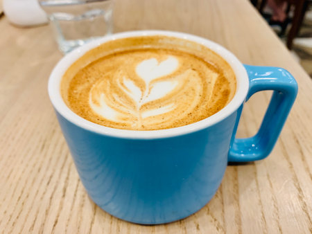 cappuccino cup blue on the brown wooden tableの写真素材